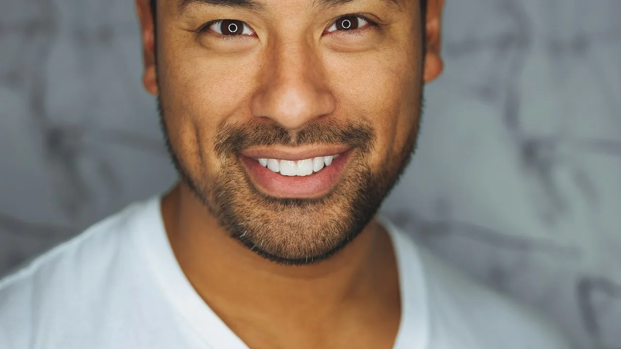 A confident professional in an office looking toward the camera