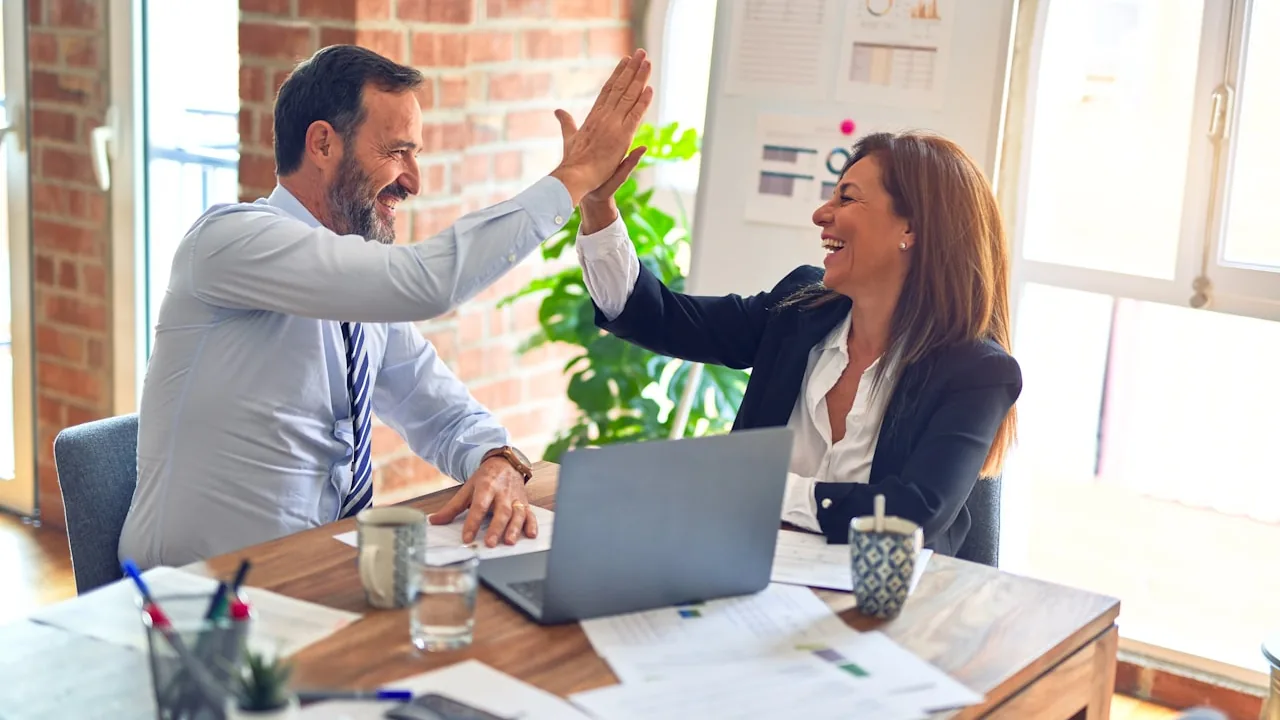 Two professionals shaking hands after a successful hire