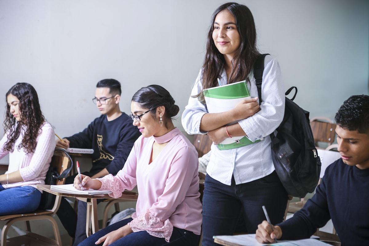 A student carrying textbooks — the right business course should be focused, recognised and fit around your life