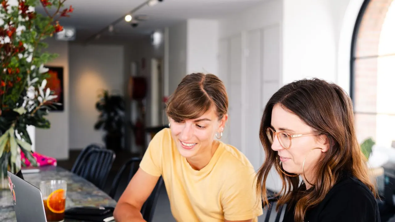 Two people discussing options across a table
