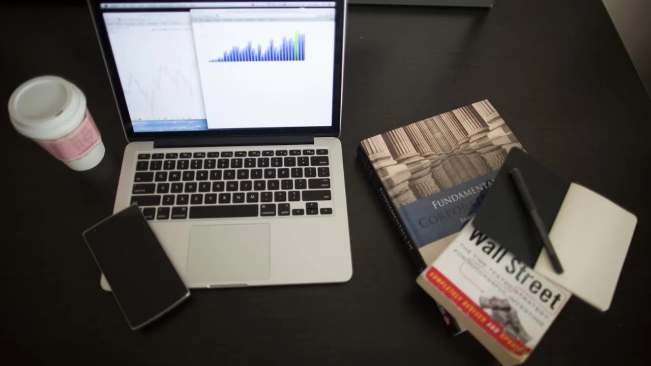 Printed charts and graphs spread across a desk for analysis