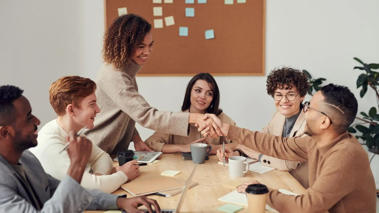 Professionals in discussion around a meeting table, weighing up a decision