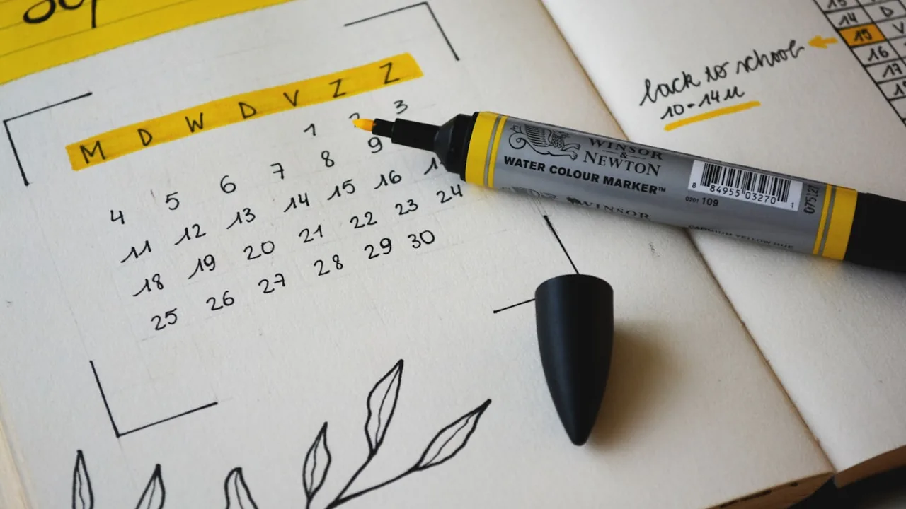 A calendar and notebook on a desk