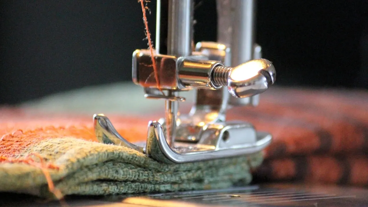 A sewing machine stitching fabric in close-up