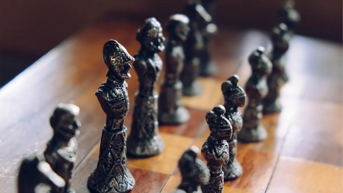 Chess pieces lined up on a board