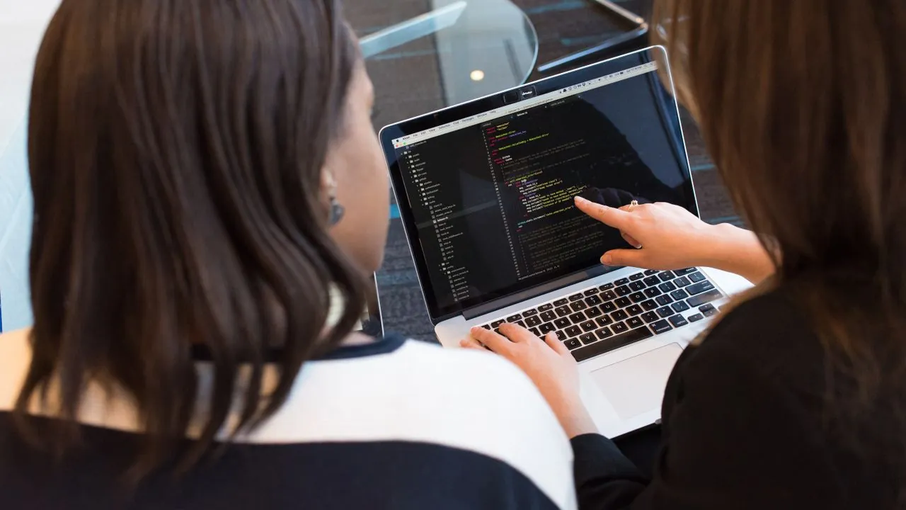 A focused professional working at a laptop, building new skills