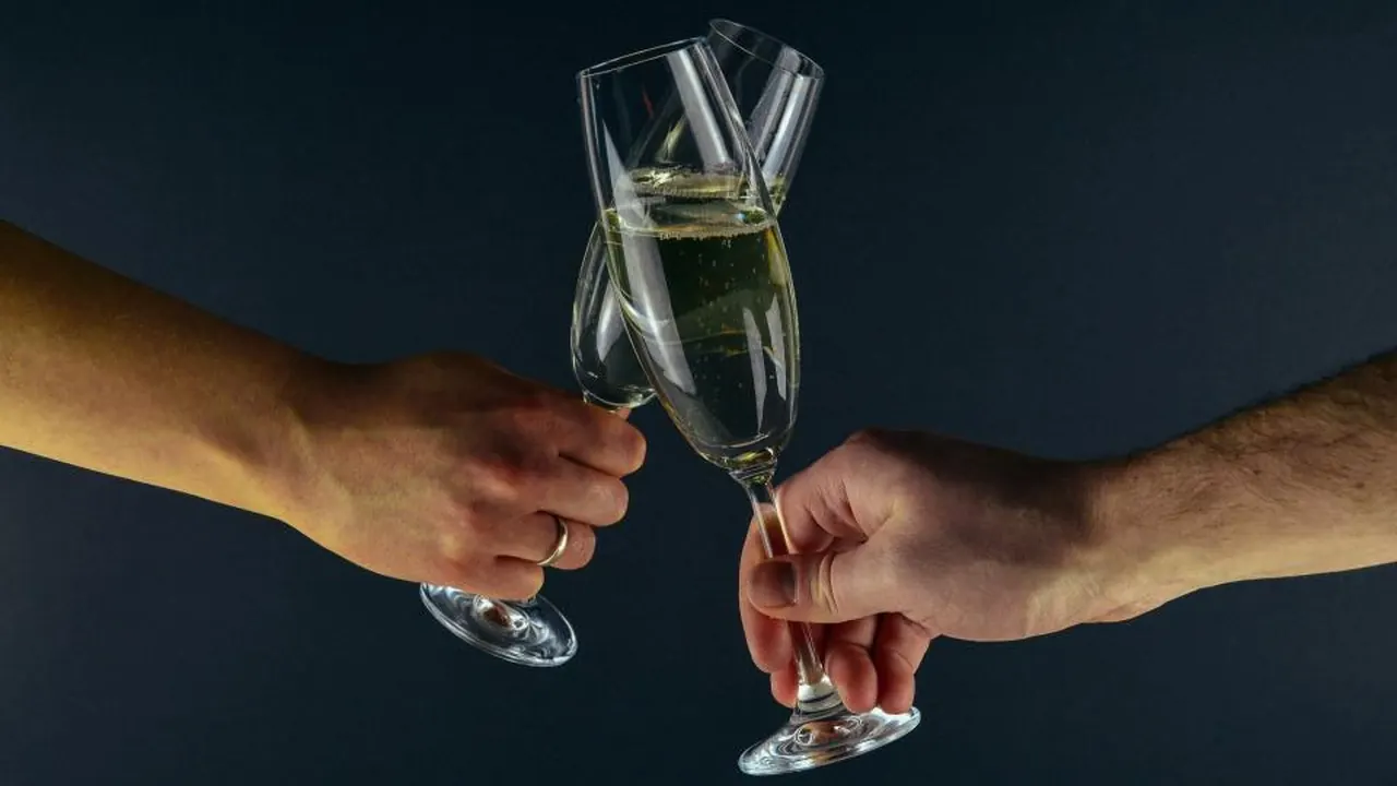 Two people raising glasses of champagne in a toast