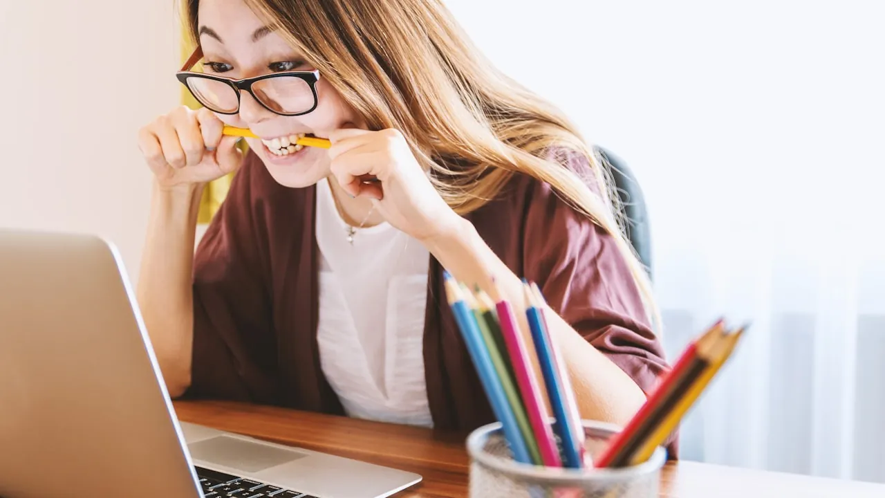 A person designing a portfolio on a laptop