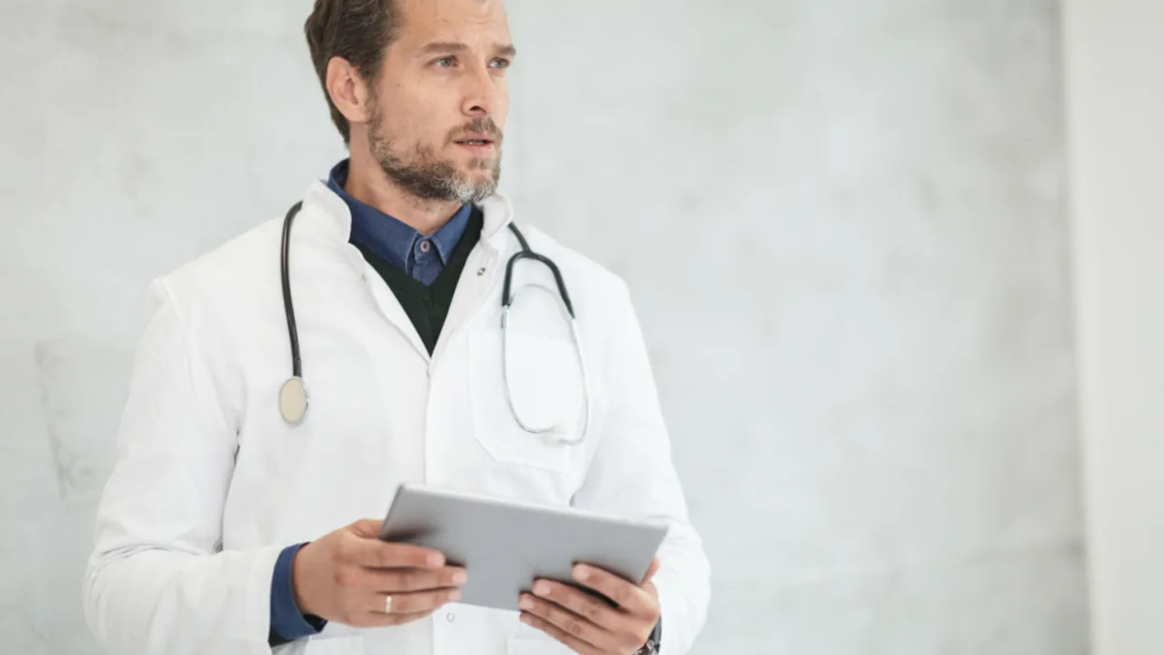 Doctor reviewing medical notes in a hospital corridor