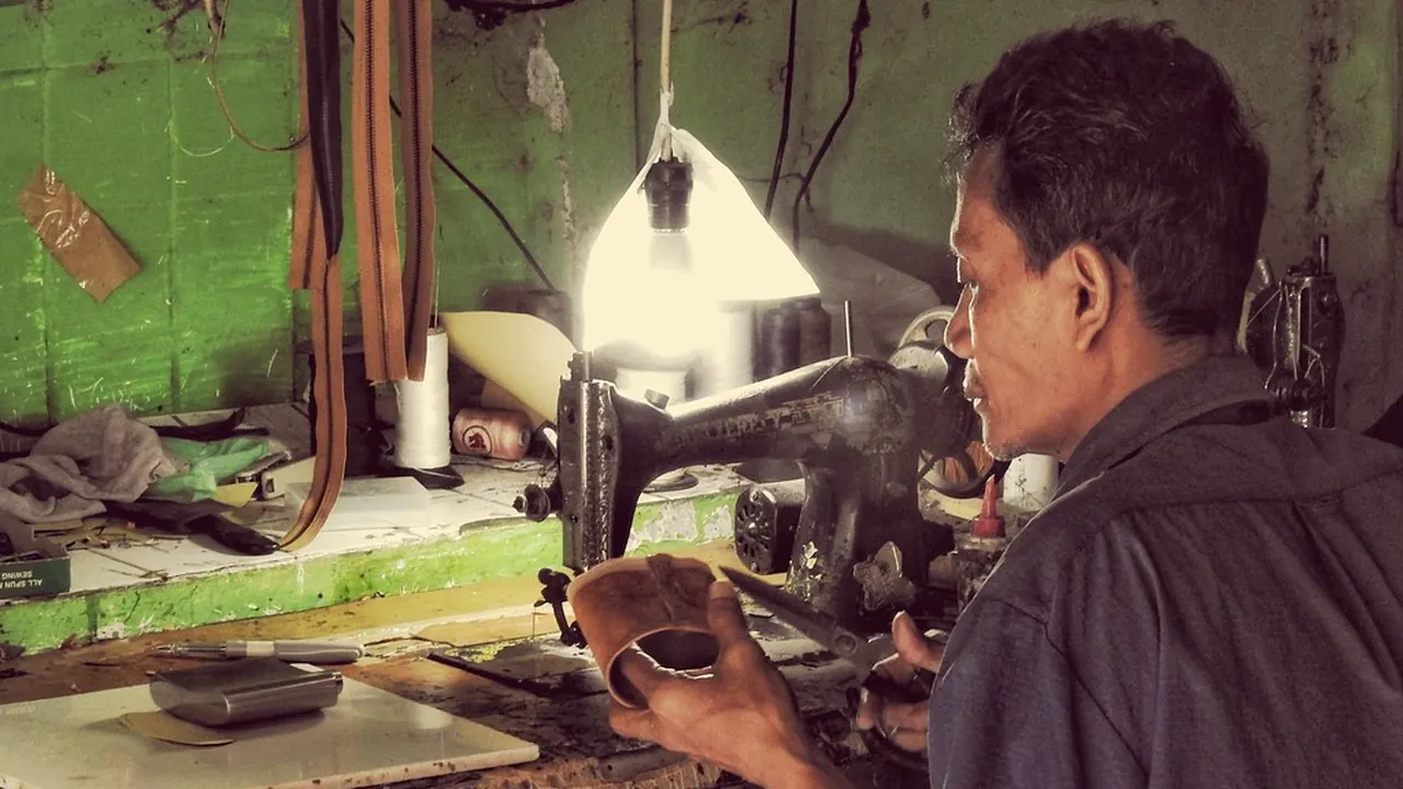 A craftsman working at a bench in a small workshop