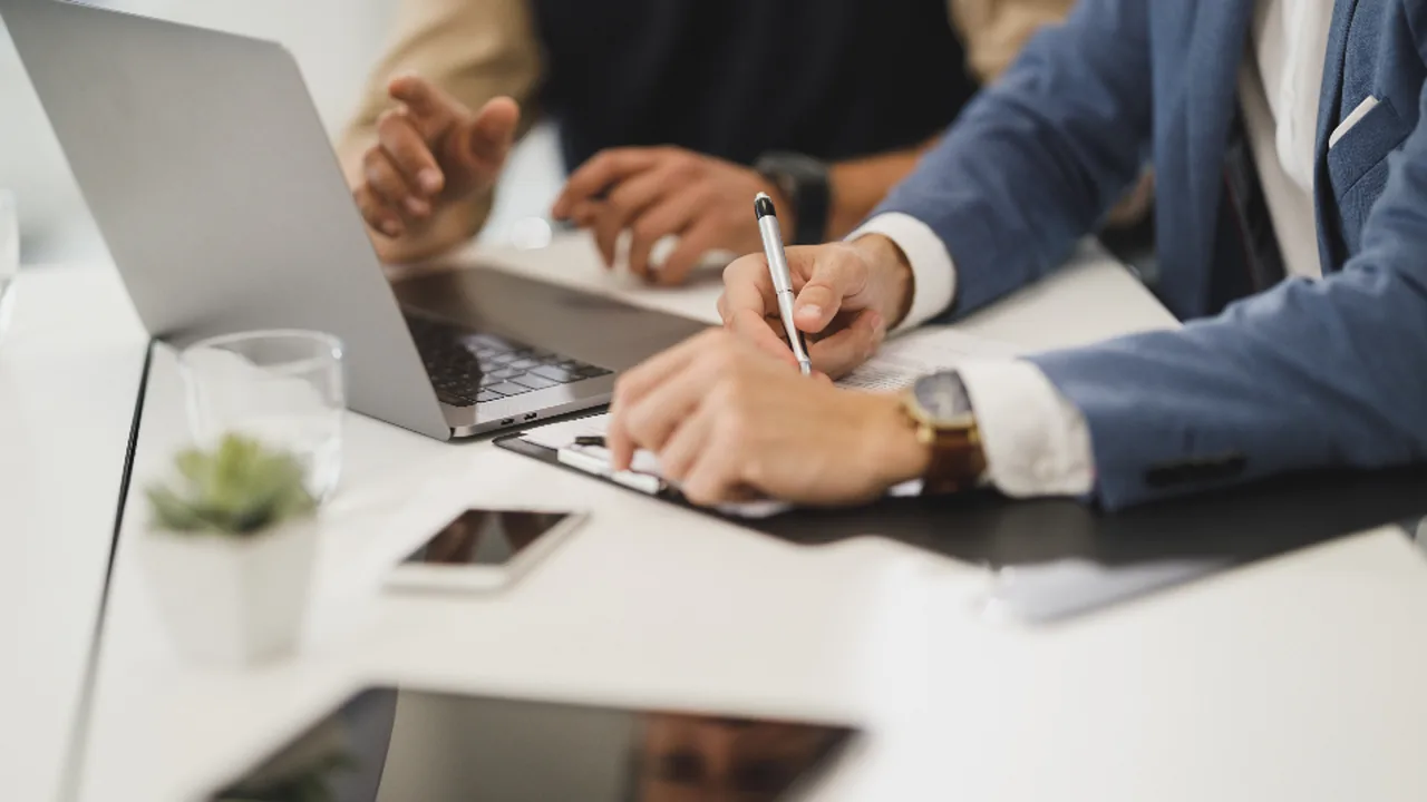 A manager reviewing performance reports at a desk