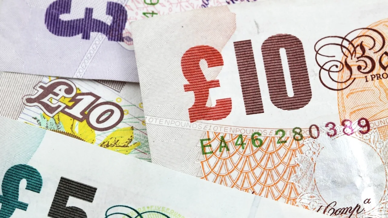 Payslip and UK currency representing salary planning