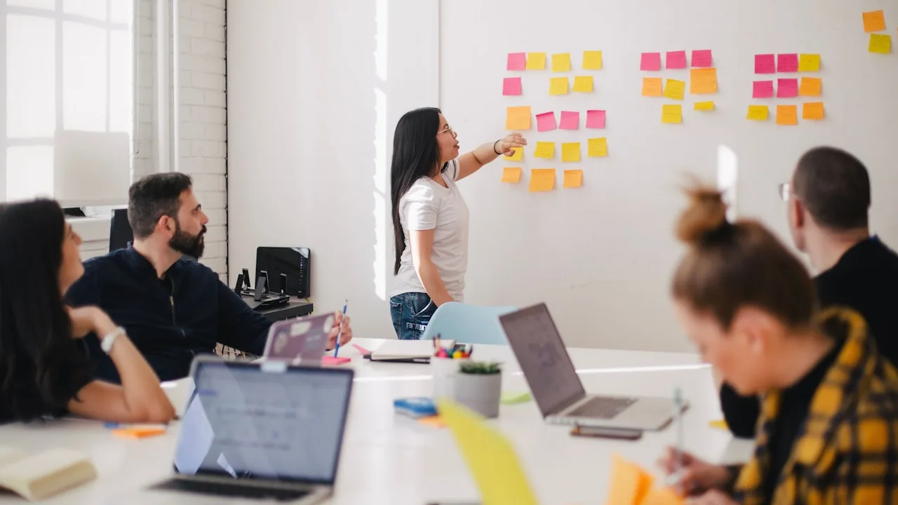 A team working through a brand strategy on sticky notes in a bright studio