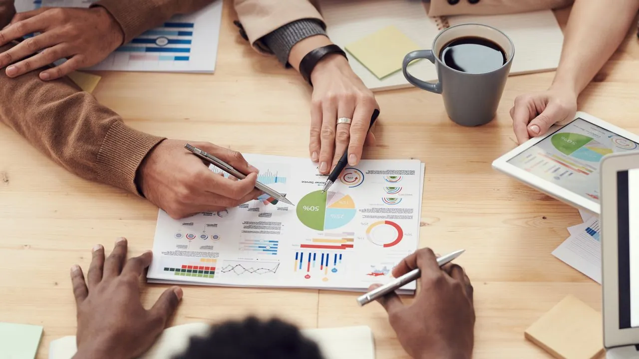 A marketing manager leading a team discussion at a shared table
