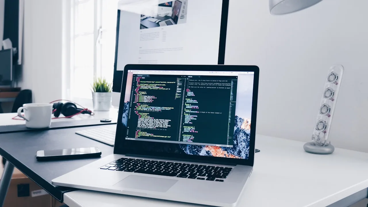 A laptop screen showing code and a workspace