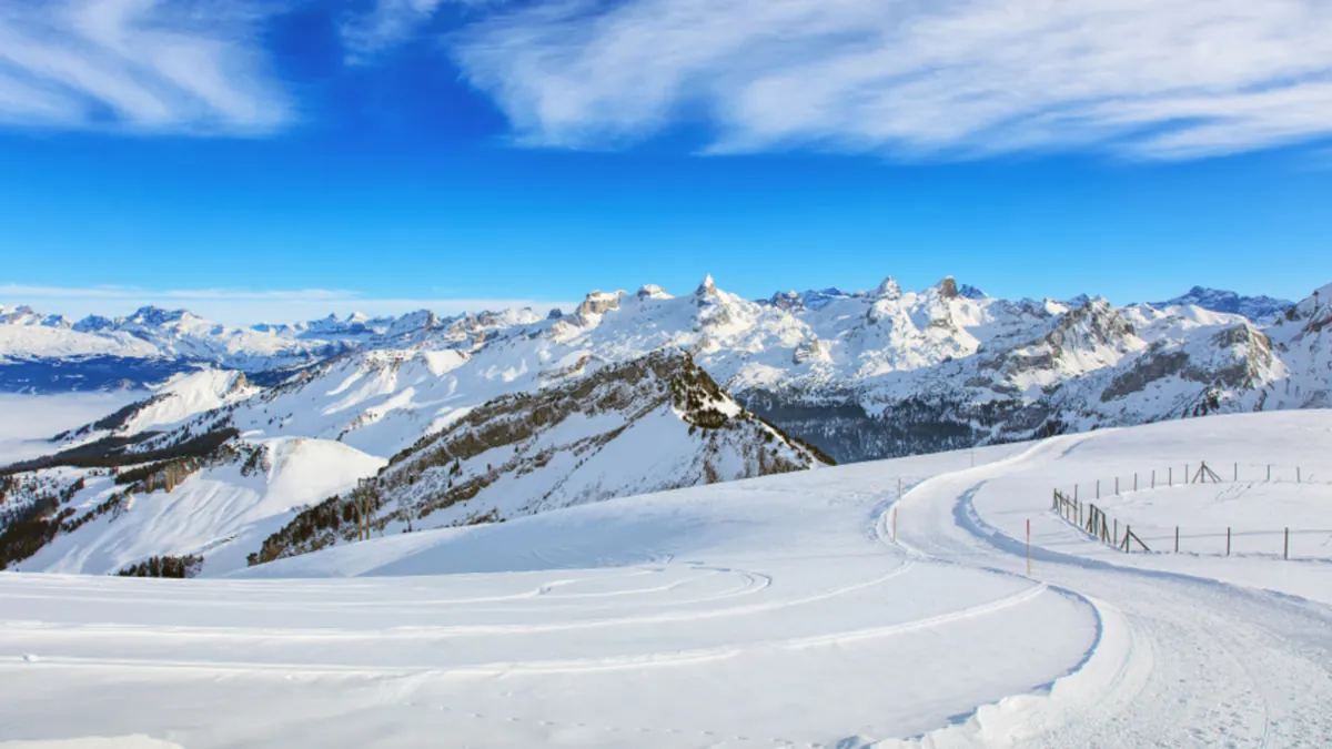 A sunny view across snow-covered mountain peaks