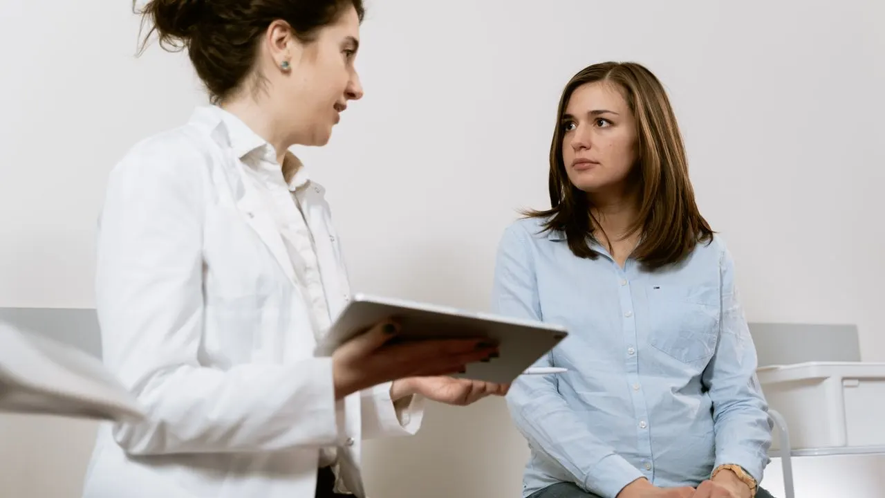 A manager showing a new team member something on a tablet