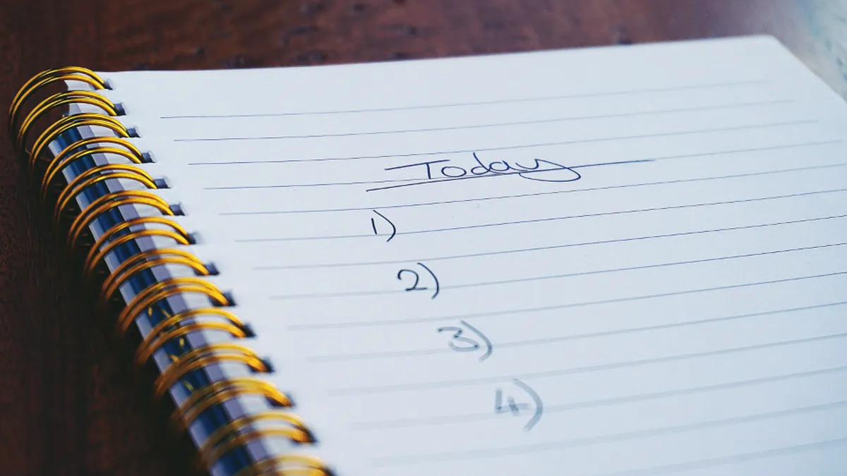 A spiral notebook with a numbered list under the heading Today